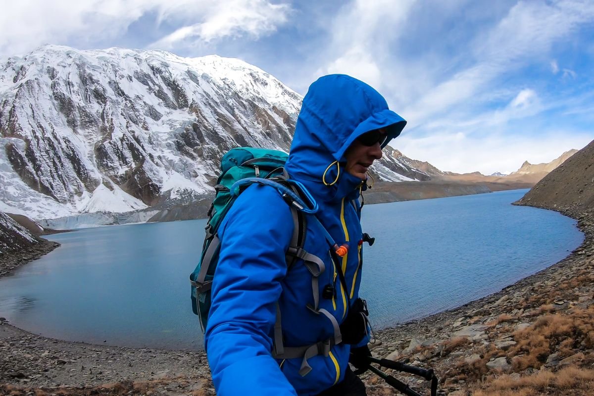 Tilicho Lake - A man taking a sefie at the shore of Tilicho lake in Himalayas