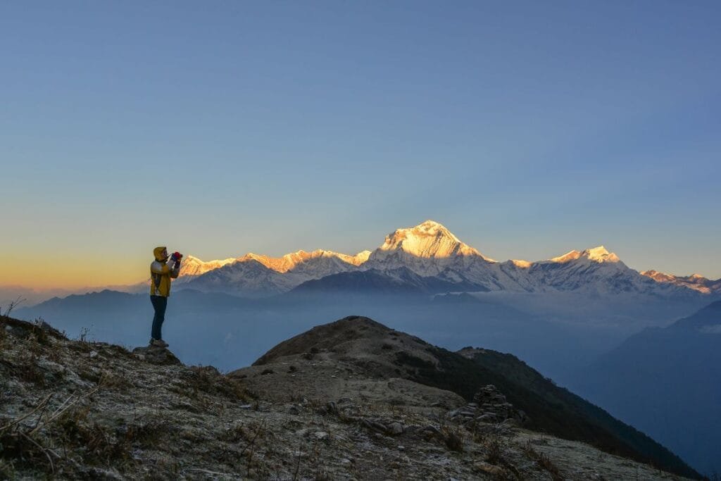 Trekker at Poon Hill, Annapurna Range view in background