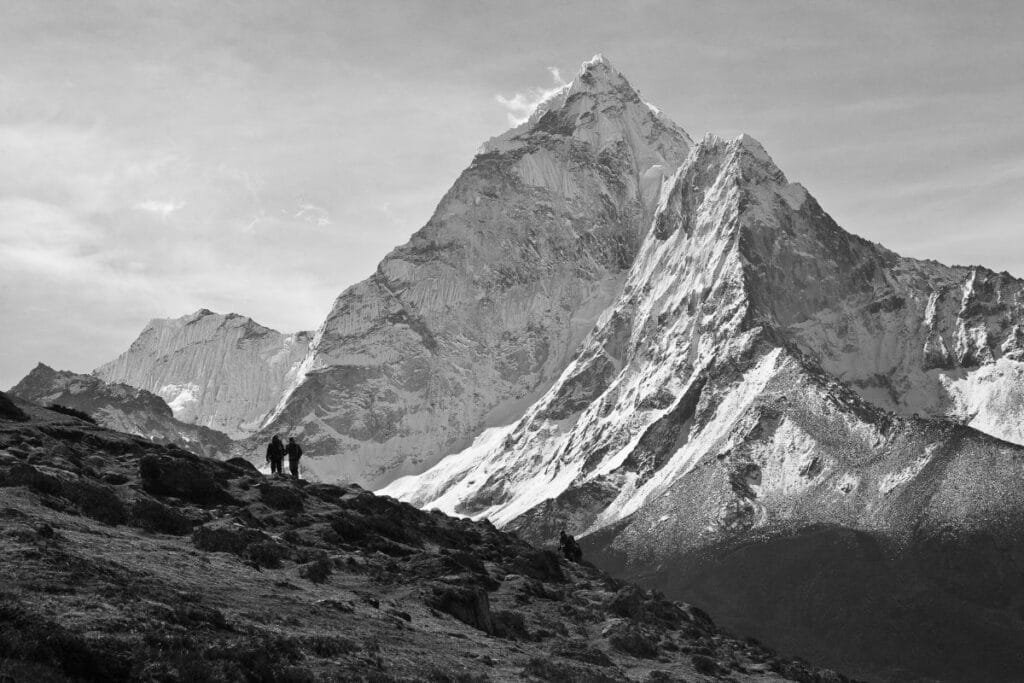 tow hikers and Mountain in Background in black and white