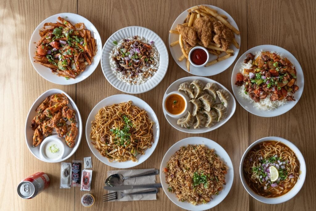 Verity of food in Table, such as momo, chaumin, fries, thukpa etc