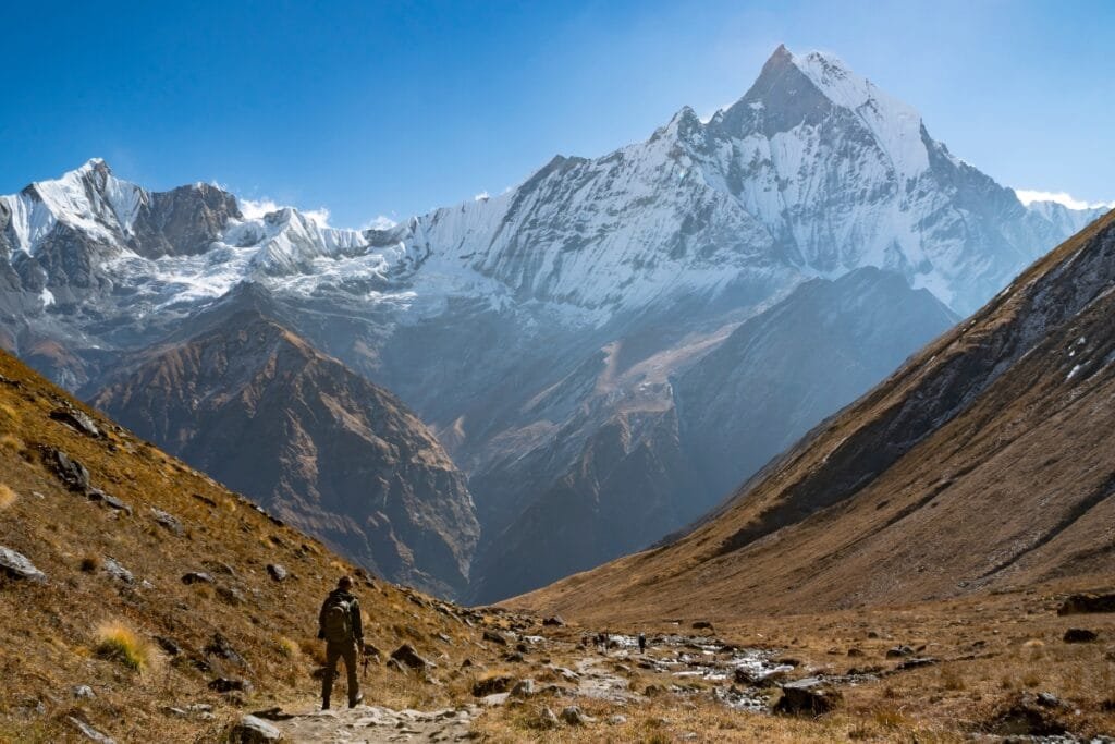 Hiker on the way to Annapurna Base Camp, Annapurna Mountain range in the background