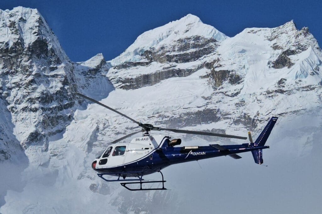 Helicopter flying over mountains, in Everest region