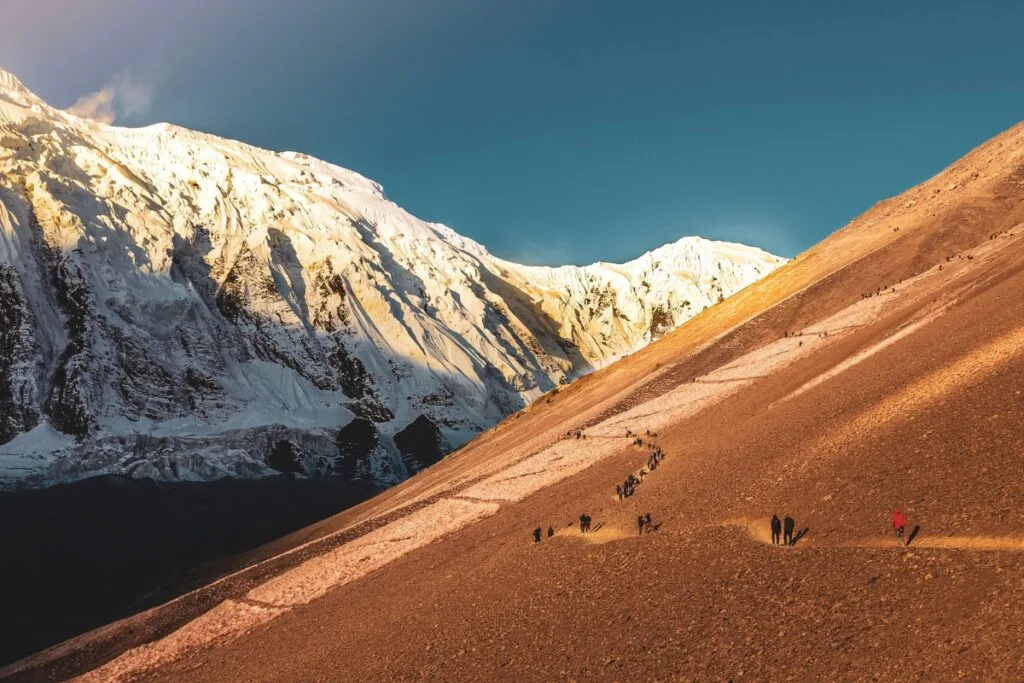 Tilicho Lake - trekkers walking along a pathway towards the Tilicho Lake